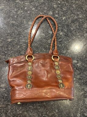 Braided-Handle Brown Leather Tote Bag with Decorative Medallions